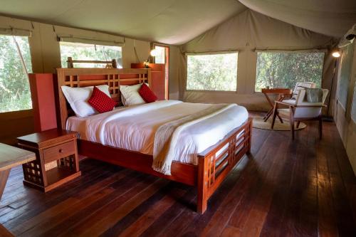 a bedroom with a bed in a tent at Oreteti Mara Lodge in Lolgorien