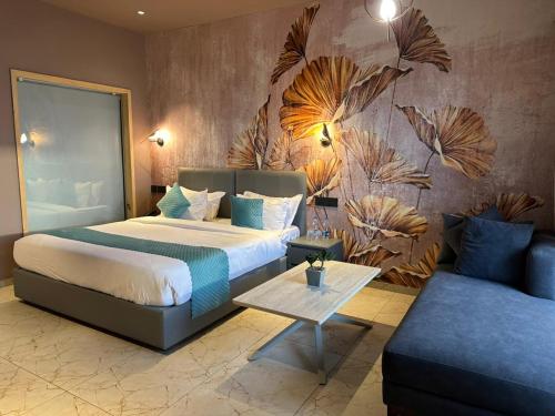 a hotel room with a bed and a couch at Le Sparrow Beach- Rooms in Mangalore