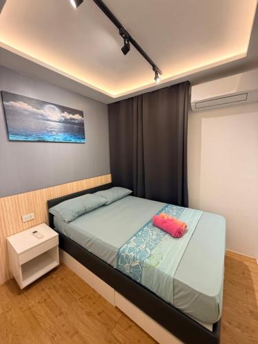 a small bedroom with a bed and a window at Sanremo Oasis Condo in Cebu City