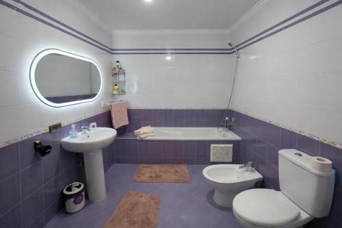 a bathroom with a toilet and a sink and a tub at Elegant & Bright Flat in the Heart of Tangier in Tangier