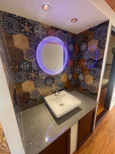 a bathroom with a sink and a mirror at Elagance Premium Houseboats in Alleppey
