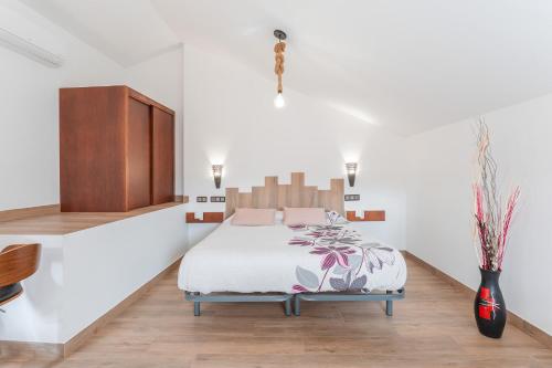 a bedroom with a bed and a cabinet at ATICO El TRANCO in Villel