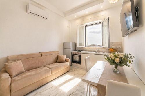a living room with a couch and a table at Frontemare Apartment by Symphonya Luxury Holiday Rentals in Gallipoli