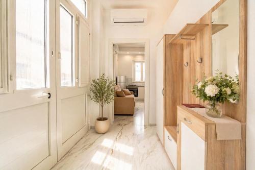 a hallway of a apartment with a door and flowers at Frontemare Apartment by Symphonya Luxury Holiday Rentals in Gallipoli