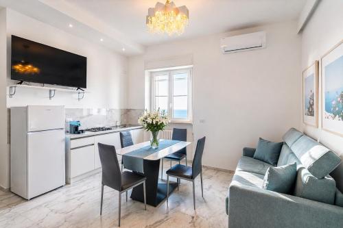 a kitchen and living room with a table and a couch at White Loft by Symphonya Luxury Holiday Rentals in Gallipoli