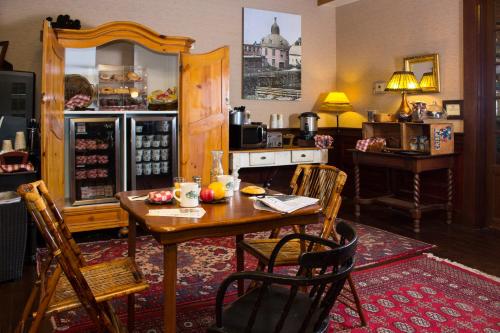 a kitchen with a wooden table and a dining room at The Common Man Inn & Restaurant in Claremont