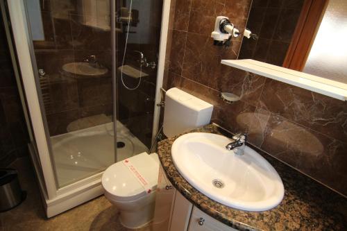 a bathroom with a sink and a toilet and a shower at Le Petit Prince Guesthouse Free Parking in Sarajevo