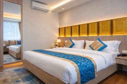 a bedroom with a large bed in a room at The Hotel Siddhi Residency near Ram Mandir in Ayodhya