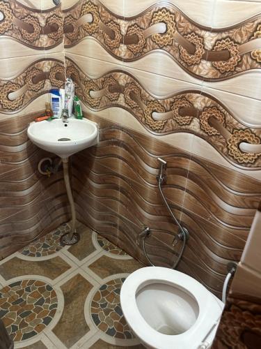 a bathroom with a toilet and a sink at Army cuisine Dine in and LUXURY NIGHTLY STAY Kurali Punjab in Kūrāli