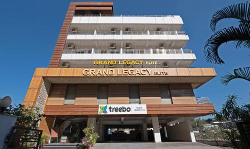 a tall building with a grand legacy club sign on it at Treebo Premium Grand Legacy Elite with Roof Top Cafe in Dehradun