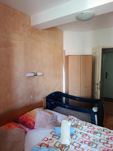 a small bedroom with a bed and a cupboard at Apartman SAN in Soko Banja