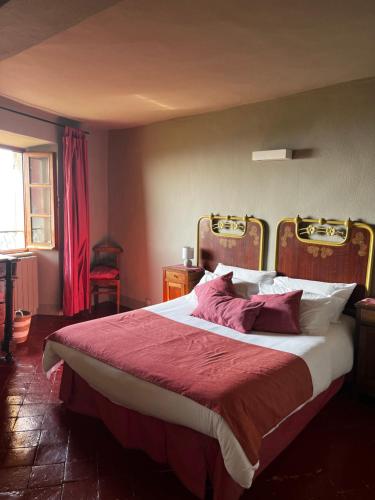 a bedroom with a large bed with a red blanket at Locanda Orticello in Monferrato in Cremolino