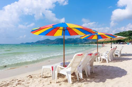 a group of chairs and umbrellas on a beach at Best Beach Bungalows in Chaweng
