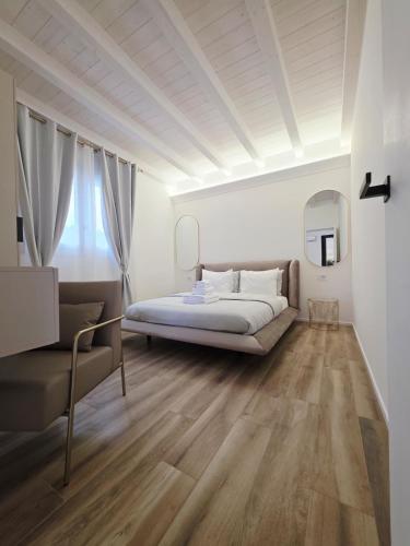 a bedroom with a bed and a couch at The K Noir Private Pool Luxury Suite in Civé
