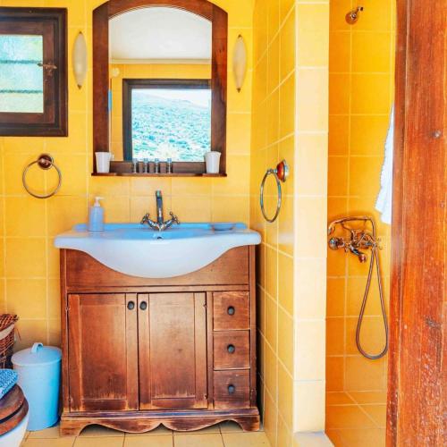 a bathroom with a sink and a mirror at The Vintage Dovecote in Mesariá