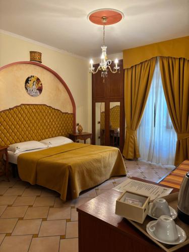 a bedroom with a large bed and a table with a table at Bed & Breakfast Casa Anna Rita in Vietri sul Mare