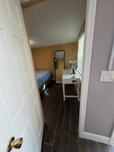 a hallway with a room with a bed and a door at Backyard Cottage in Naples