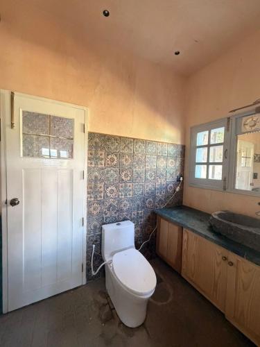 a bathroom with a toilet and a sink at The Amar Vilas in Dehradun