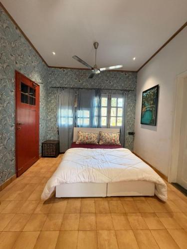 a bedroom with a bed and a ceiling fan at The Amar Vilas in Dehradun