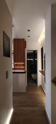 a kitchen with white cabinets and a wooden floor at Celestial Luxury SKG Port in Thessaloniki