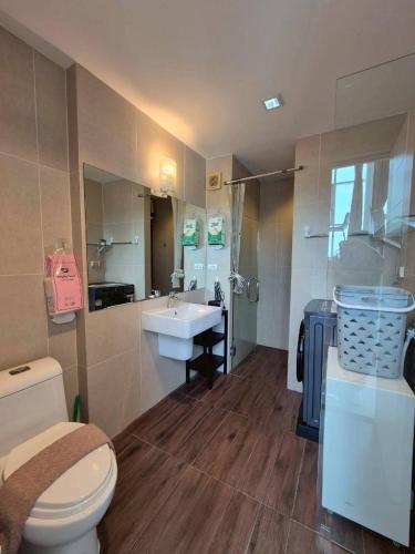 a bathroom with a toilet and a sink at Mosaic condominium RoomBD64M in Klaeng