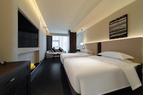 a row of beds in a hotel room at Chengdu Yunduo 云朵Hotel in Chengdu