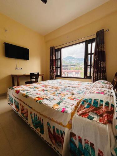 a bedroom with a bed and a large window at The Hp 39 House in Dharmsāla