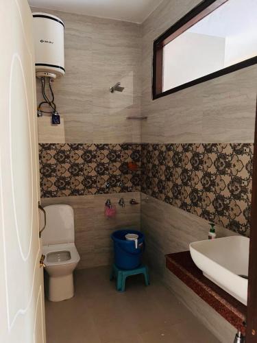 a bathroom with a toilet and a sink and a tub at The Hp 39 House in Dharmsāla