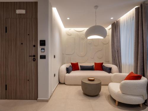 a living room with a couch and a chair at Space Row Exclusive Residences in Heraklio