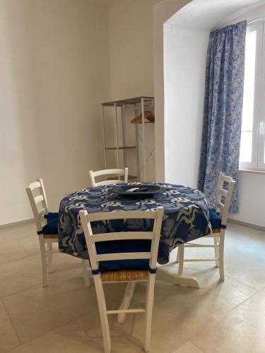 a dining room table with a blue and white table cloth at Trame - La Naca sul Porto in Polignano a Mare