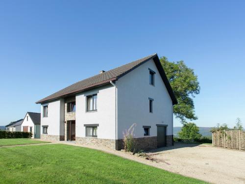 a white house with a gambrel roof at Vintage Villa with Private Garden in Rendeux in Magoster
