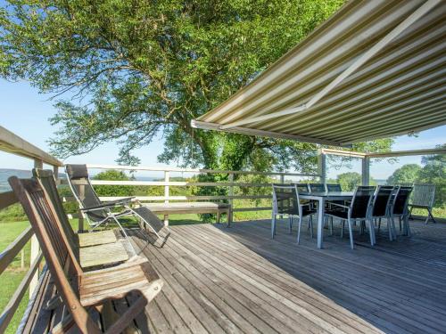 a wooden deck with a table and chairs on it at Vintage Villa with Private Garden in Rendeux in Magoster
