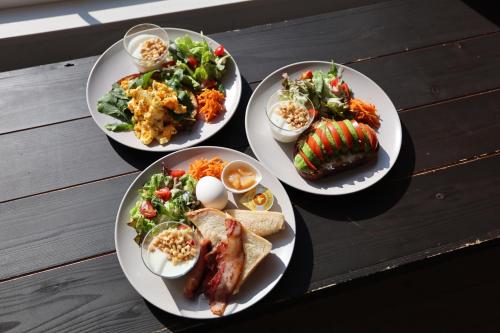 four plates of food on a wooden table at Hakuba Hatago Maruhachi in Hakuba