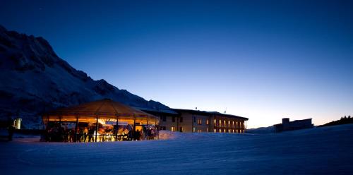 a gazebo in the snow in front of a building at Grand Hotel Paradiso in Passo del Tonale