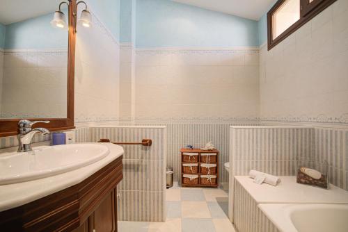 a bathroom with a sink and a tub and a toilet at Capavila by Rentallorca in Muro