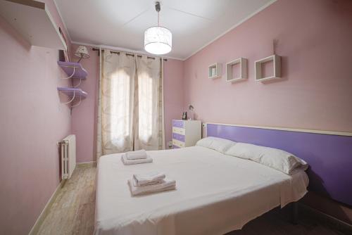 a bedroom with a white bed with purple walls at Capavila by Rentallorca in Muro