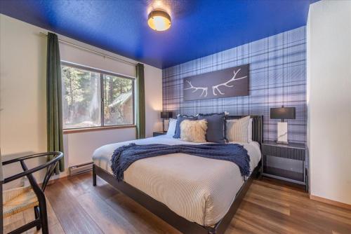 a bedroom with a bed with a blue ceiling at Donner Lake Outpost home in Truckee