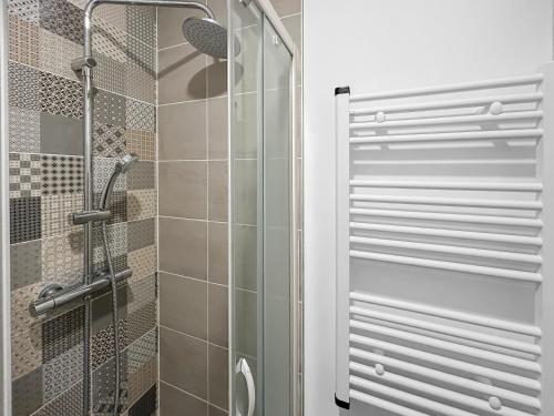 a shower with a glass door in a bathroom at Suite GrandLarge in Berck-sur-Mer