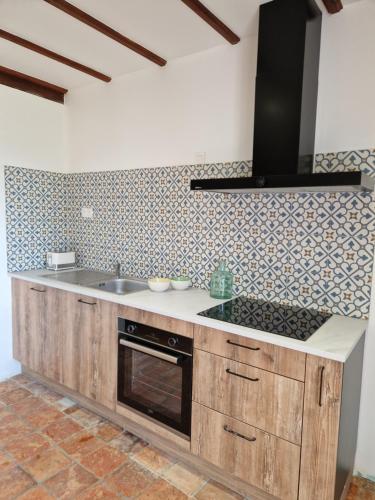 a kitchen with a sink and a stove at La maison Argonnaise in beaulieu en argonne