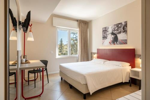 a bedroom with a bed and a desk and a table at Guesthouse Verona in Verona
