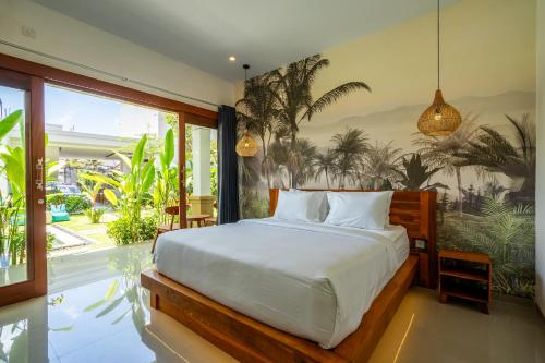 a bedroom with a bed and a large window at Maha Prana Kedungu by Aayan in Tanah Lot