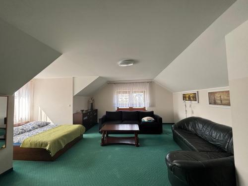 a living room with a bed and a couch at Apartamenty LeVilla in Rewa