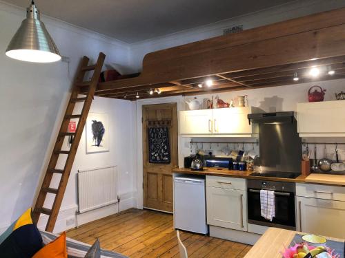 a kitchen with a loft bed in a room at Artistic spacious flat in central Brixton in London