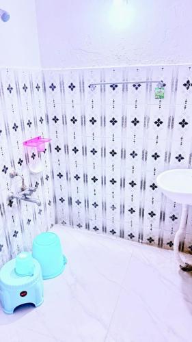 a bathroom with a toilet and a sink at Hotel Shubham in Karīmnagar
