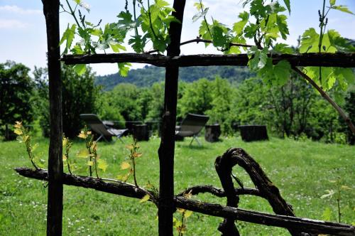 a fence with chairs in a field of grass at Agriturismo La Costa - Casa Vacanze in Perego