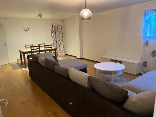 a living room with a couch and a table at 2 bedrooms 1 bathroom kitchen apartment in Stockholm