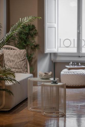 a living room with two tables and a couch at Rooms Buonanotte Barbarossa in Prato