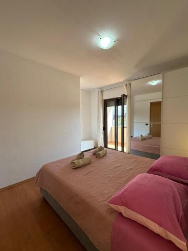 a bedroom with a large bed with two towels on it at Apartment Nina with private pool in Nova Vas