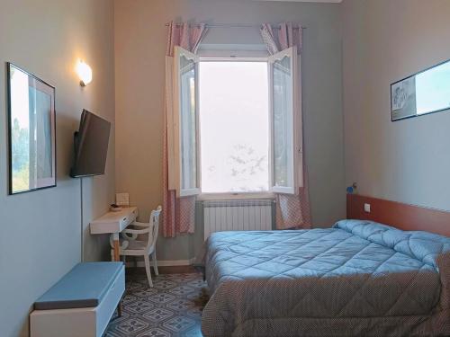 a small bedroom with a bed and a window at Villa Al Piano in Lastra a Signa