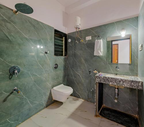 a bathroom with a toilet and a shower at Majestic Royal by Travel Pleasure Hotels in Akalkot